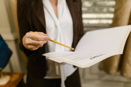 Business professional reviewing workplace contract documents during an employment dispute affecting business operations